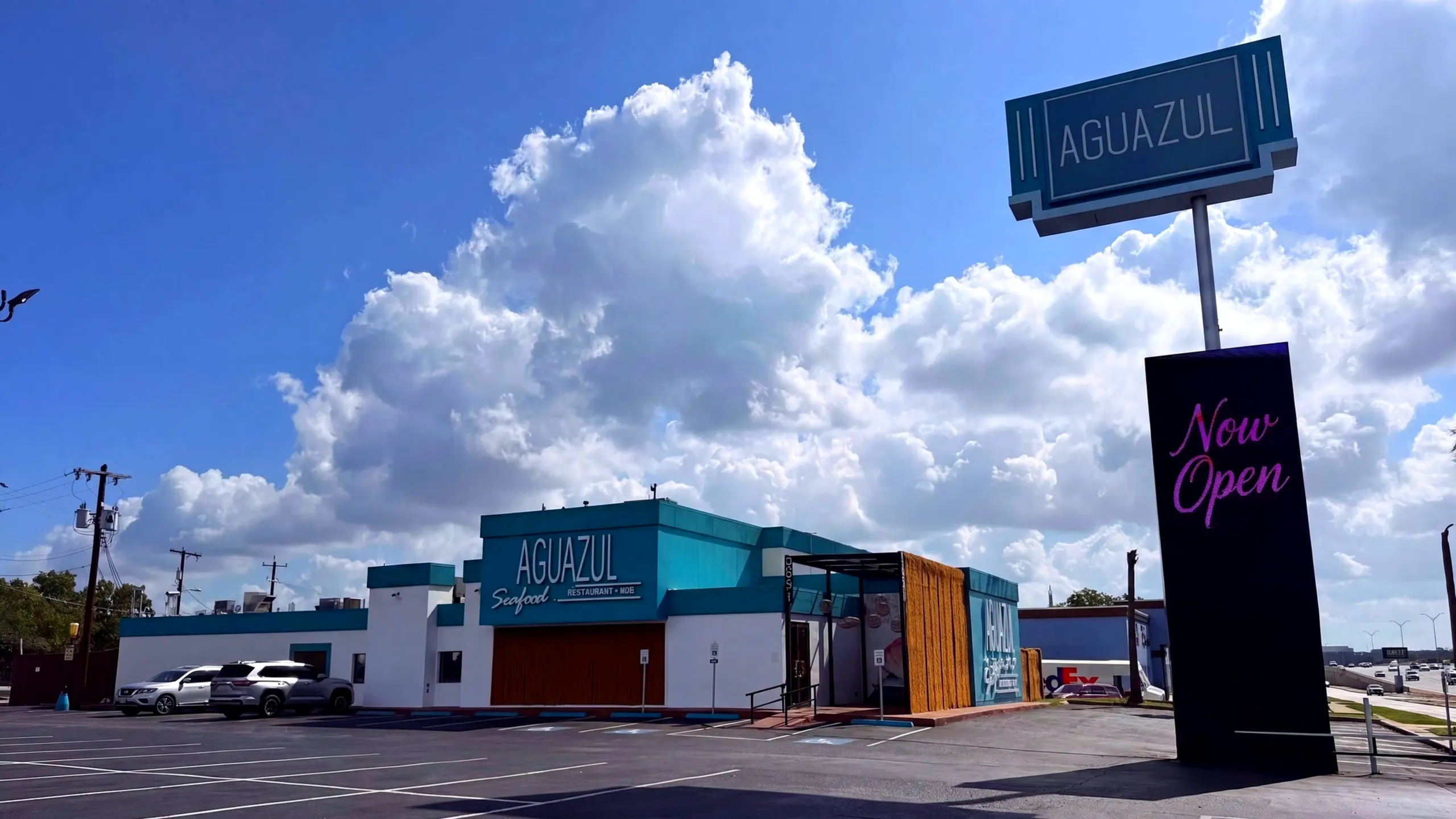 Aguazul Seafood Restaurant + Bar — teal storefront under a bright Texas sky on NW Loop 410, San Antonio